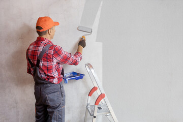 Wall Mural - Painter painting a wall with paint roller. Home decoration, repair concept