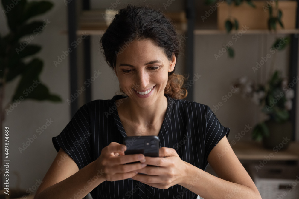 Close up smiling woman using smartphone, browsing mobile device apps, chatting with friends in social networks, happy attractive young female looking at screen, typing, writing message, scrolling - obrazy, fototapety, plakaty 