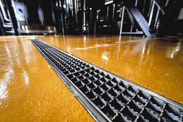 stainless steel floor drain at a modern beer factory