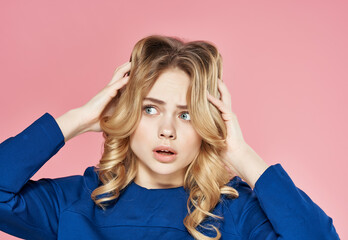 pretty blonde in blue dress displeasure emotions studio pink background