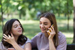 © hannamartysheva - Mom and teenage daughter use a smartphone for a walk in a summer park
