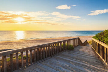 Wall Mural - Boardwalk to O'Sullivan Beach with no people at sunset during a warm summer evening, South Australia