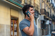 © Viviland - Young latin man in the city talking by mobile phone.