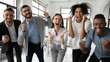 © fizkes - Portrait of overjoyed young diverse employees workers show thumb up recommend good quality company service. Smiling multiethnic colleagues celebrate shared business success or victory in office.