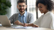 © fizkes - Close up of smiling young African American female employee sign document close deal with male business partner at office meeting. Happy ethnic woman put signature on paperwork make agreement.