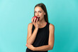 © luismolinero - Young woman over isolated blue background eating an apple