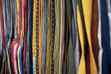 Lots of multicolored shoelaces displayed for sale on the street