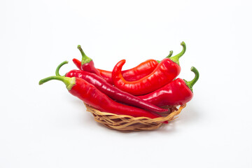 Canvas Print - Red hot peppers in a basket on a white background. Chili pepper isolated