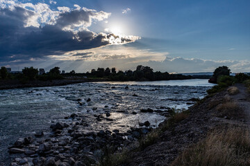 Canvas Print - Beautiful sunset over Sava river rapids in Zagreb city, with storm clouds approaching fast, bringing heavy rain