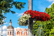 Lamppost Decorated With White And Red Petunias