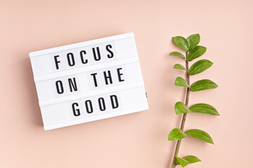Wall Mural - Lightbox with text focus on the good. Mental health, positive thinking, emotional wellness concept. Flat lay, top view