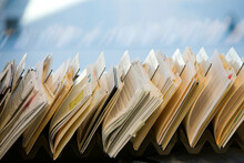 Close-up Of Files Stacked On Desk In Office