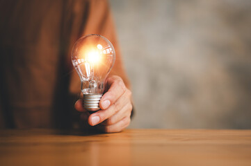 Poster - Innovation. Hands holding light bulb for Concept new idea concept with innovation and inspiration, innovative technology in science and communication concept.