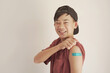 © SewcreamStudio - Mixed Asian teen boy showing his arm with blue bandage after got vaccinated or  inoculation, child immunization, covid delta vaccine concept