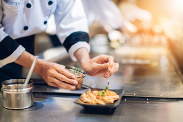 Wall Mural - Hand of man take cooking of meat with vegetable grill, Chef cooking wagyu beef in Japanese teppanyaki restaurant