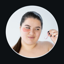 Face Treatment. Skeptic Woman. Plus Size Beauty. Hard Result. Smooth Skin. Disbelief Curvy Lady Looking On Under Eye Collagen Pad With Distrust Isolated White Black Circle Frame.