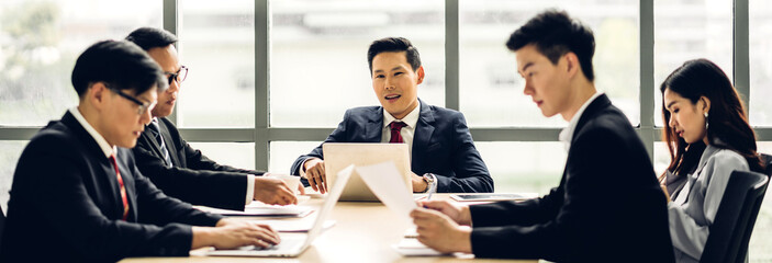 Wall Mural - Group of asian professional business meeting and discussing with new startup idea project.Creative business people planning strategy analysis and brainstorm with document report in office.Teamwork