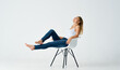 © SHOTPRIME STUDIO - woman in jeans sitting on a white chair emotion home isolated background