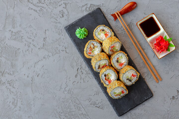 Wall Mural - Japanese sushi tempura roll served on black stone plate