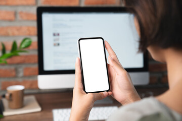 Aufkleber - female holding phone blank screen third person view clippig path inside