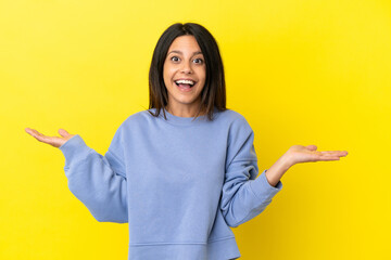 Poster - Young caucasian woman isolated on yellow background with shocked facial expression