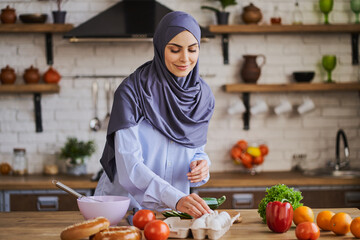 Muslim housewife cooking a meal in the kitchen