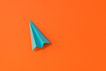 Top View Photo Of Vivid Blue Paper Airplane On Isolated Orange Background With Empty Space