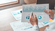 © Puwasit Inyavileart - Asian businessmen are analyzing graphs, Financial statistics and calculating corporate returns in private offices, Market research reports and income statistics, Financial and Accounting concept.