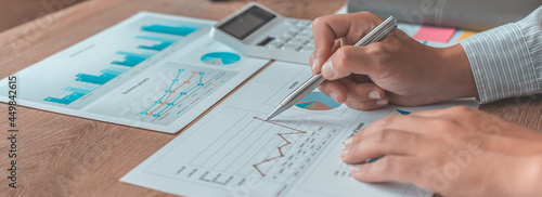 Asian businessmen are analyzing graphs, Financial statistics and calculating corporate returns in private offices, Market research reports and income statistics, Financial and Accounting concept.