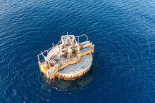 Aerial View Of An Abandoned Offshore Platform With Pipelines In Deep Sea Or Ocean 