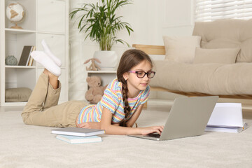 Sticker - Girl with laptop and books lying on floor at home