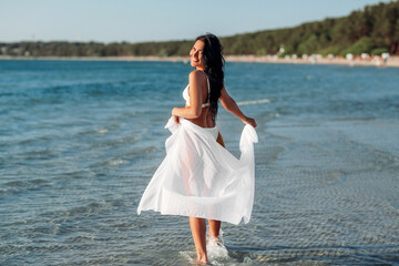 Sticker - people, summer and swimwear concept - happy smiling young woman in bikini swimsuit with cover-up on beach