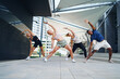 © Halfpoint - Group of young and old people doing exercise outdoors in city.