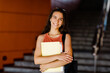 © Sviatlana - Portrait of a smiling girl with a folder in her hands