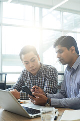 Mobile app developer meeting with UX designer when they are discussing and testing new interface for application on smartphone