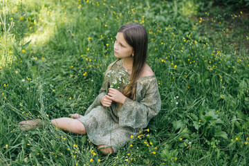 beautiful attractive stylish girl in green dress holding flower, romantic mood, posing in summer fashion style, natural look