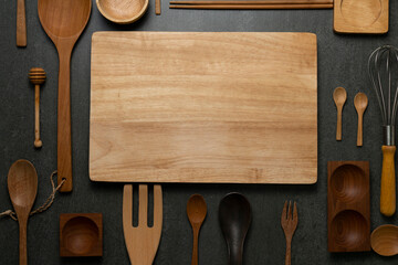 Wall Mural - kitchen wooden utensils for cooking on the black table backcround, food prepare concept