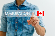 Concept Of Immigration To Canada With Virtual Button Pressing