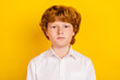 © deagreez - Photo of young serious calm peaceful thoughtful schoolboy thinking brainstorming isolated on yellow color background