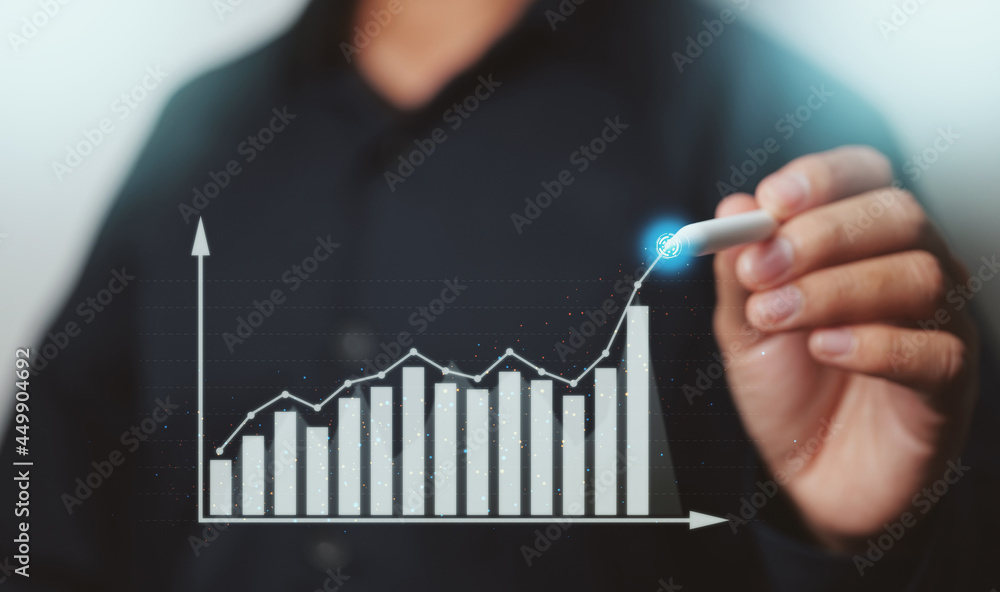 Businessman showing business growth on a chart with pen, hands touch ...