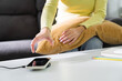 © mojo_cp - Woman hands plugging a charger in a smart phone. Charging Smartphone with Wireless Charging Pad at Home