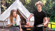 © frimufilms - Young couple frying meat on the grill and drinking beer