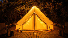 Glamping At Night, Glowing Tent With Chairs In Front Of It