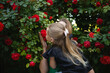 © Aleksandra Iarosh - mom hugs her little daughter against the background of a rose bush