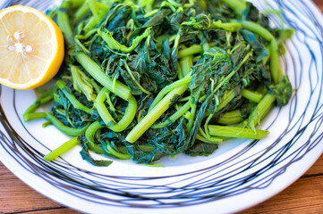 Sticker - Amaranthus blitum . Vlita Salad on a plate, on a wooden old table