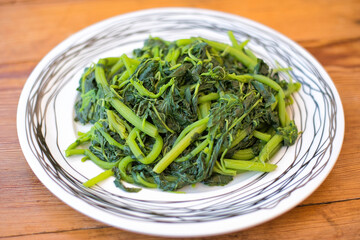 Poster - Amaranthus blitum . Vlita Salad on a plate, on a wooden old table