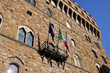 Flags on the facade of the Palazzo Vecchio on the Piazza della Signoria, Florence, Italy.