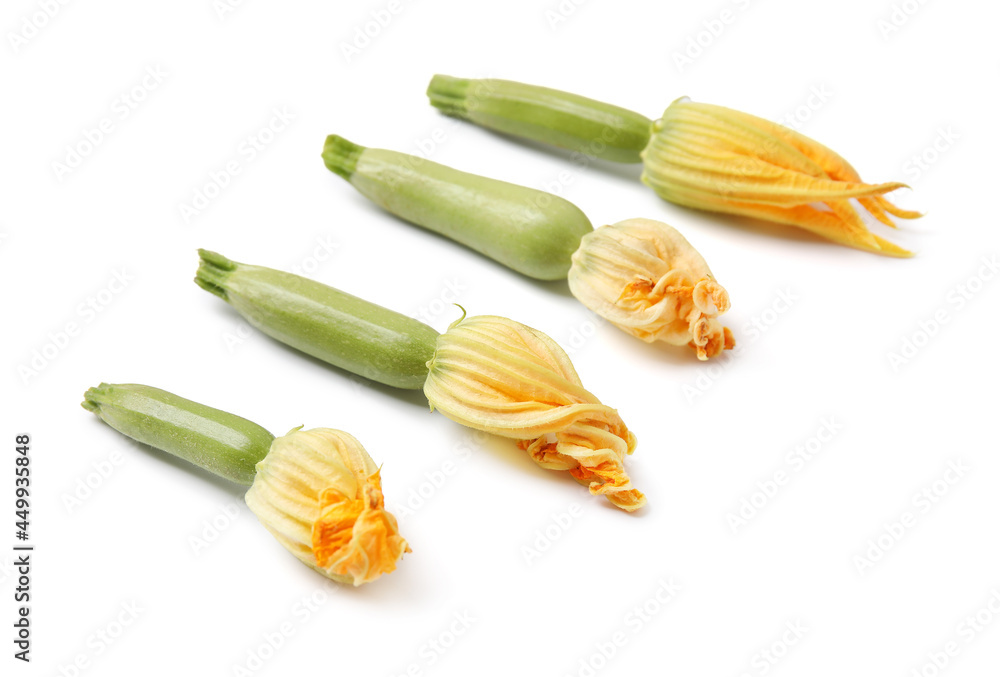 Fresh zucchini with flowers on white background