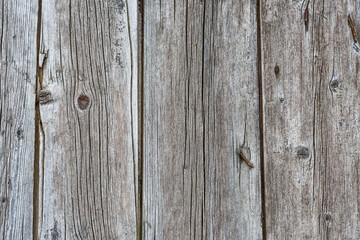 Old wooden fence gray-brown boards with cracked. Beautiful textured background for design.Old Vintage Rough Wood Bars Fence Texture Background.