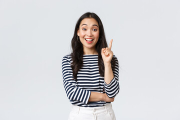 Lifestyle, people emotions and casual concept. Excited smart and creative asian female coworker have suggestion, add idea, raising index finger to say thought or plan, standing white background